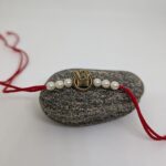 Om Rakhi With White Pearls