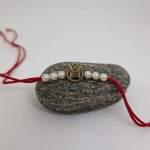 Om Rakhi With White Pearls