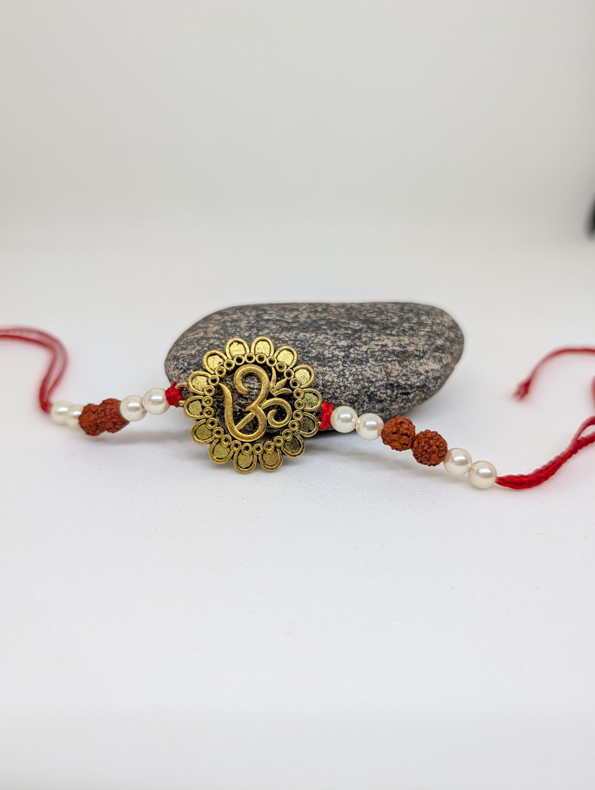 Om Rakhi With Rudraksh and Pearls